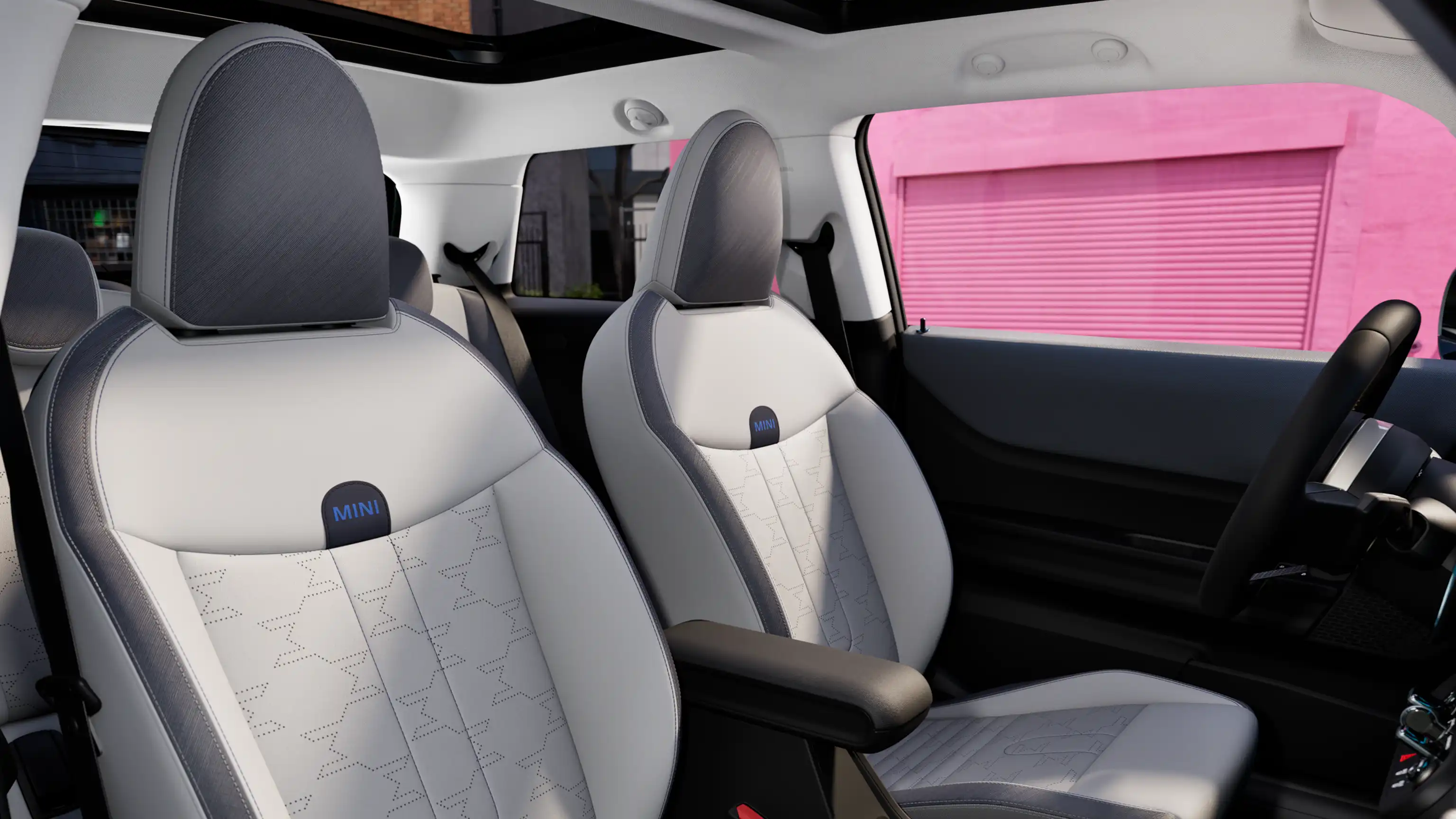 Unutarnja perspektiva MINI Coopera modela prikazuje nadzornu ploču, volan, okrugli zaslon, panoramski stakleni krov i naslon prednjih sjedala.